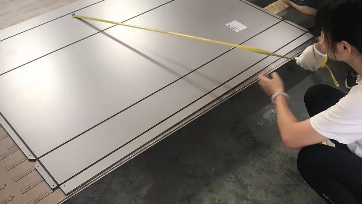 Alcadex technician checking ACP fabrication dimensions before V-grooving