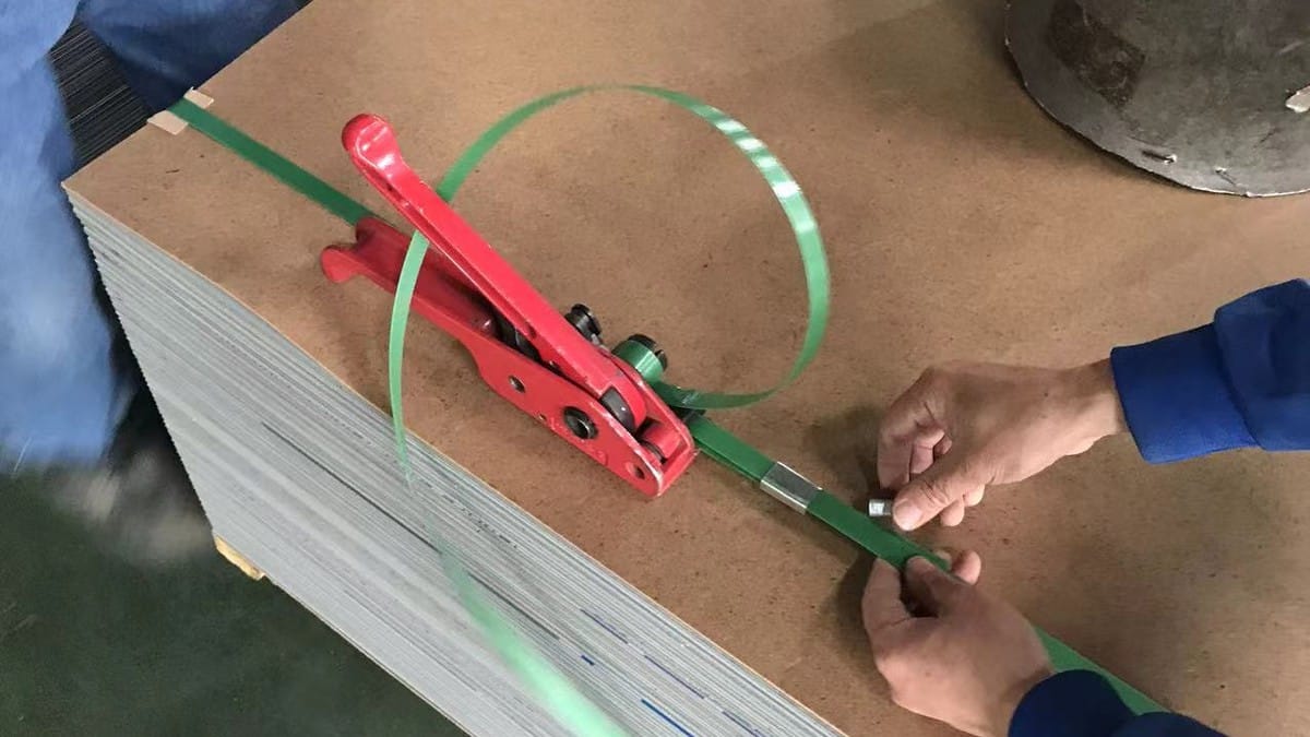 Alcadex ACP bundle strap being tensioned over a protective cover board